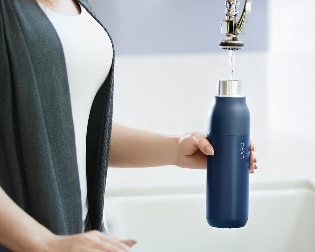 Larq purevis&trade; bottle being filled with water