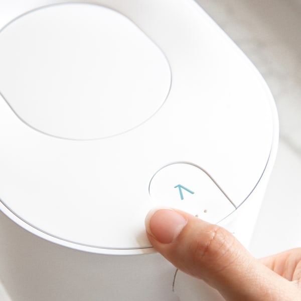 Photo of Larq Pitcher PureVis&trade; - Pure White with finger on activation button