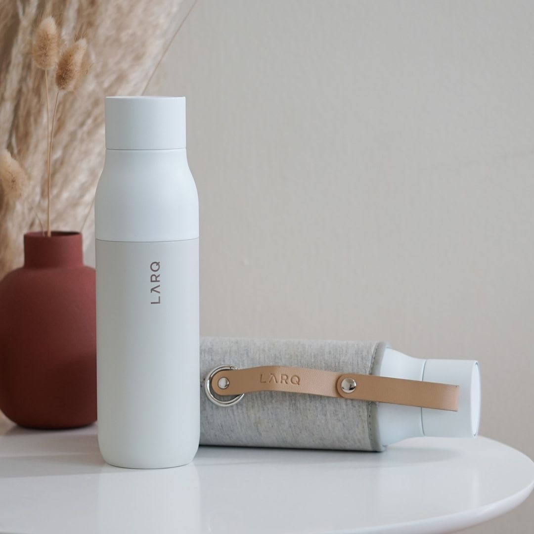 Photo of LARQ Bottle PureVis&trade; - Granite White in Travel Sleeve on table