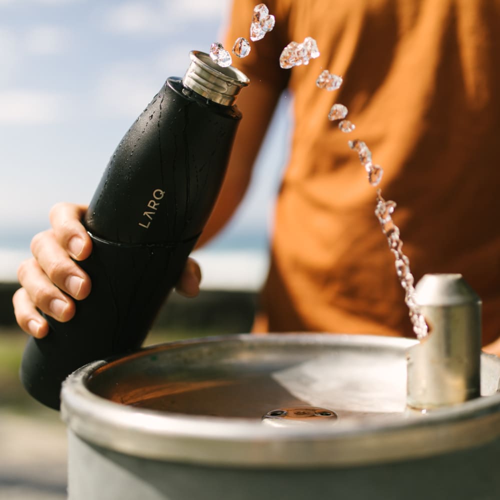 Larq purevis&trade; bottle being filled with water
