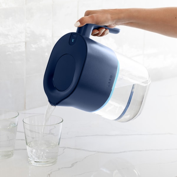 Photo of Larq Pitcher PureVis&trade; - Monaco Blue pouring water in glass