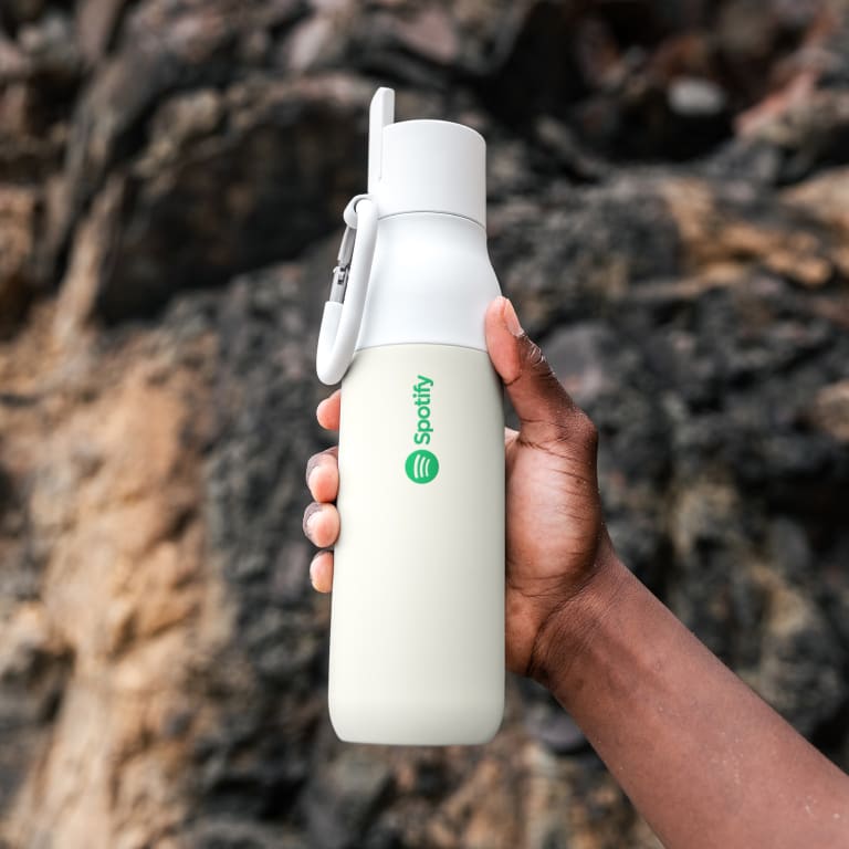 Man holding LARQ bottle with Spotify branding