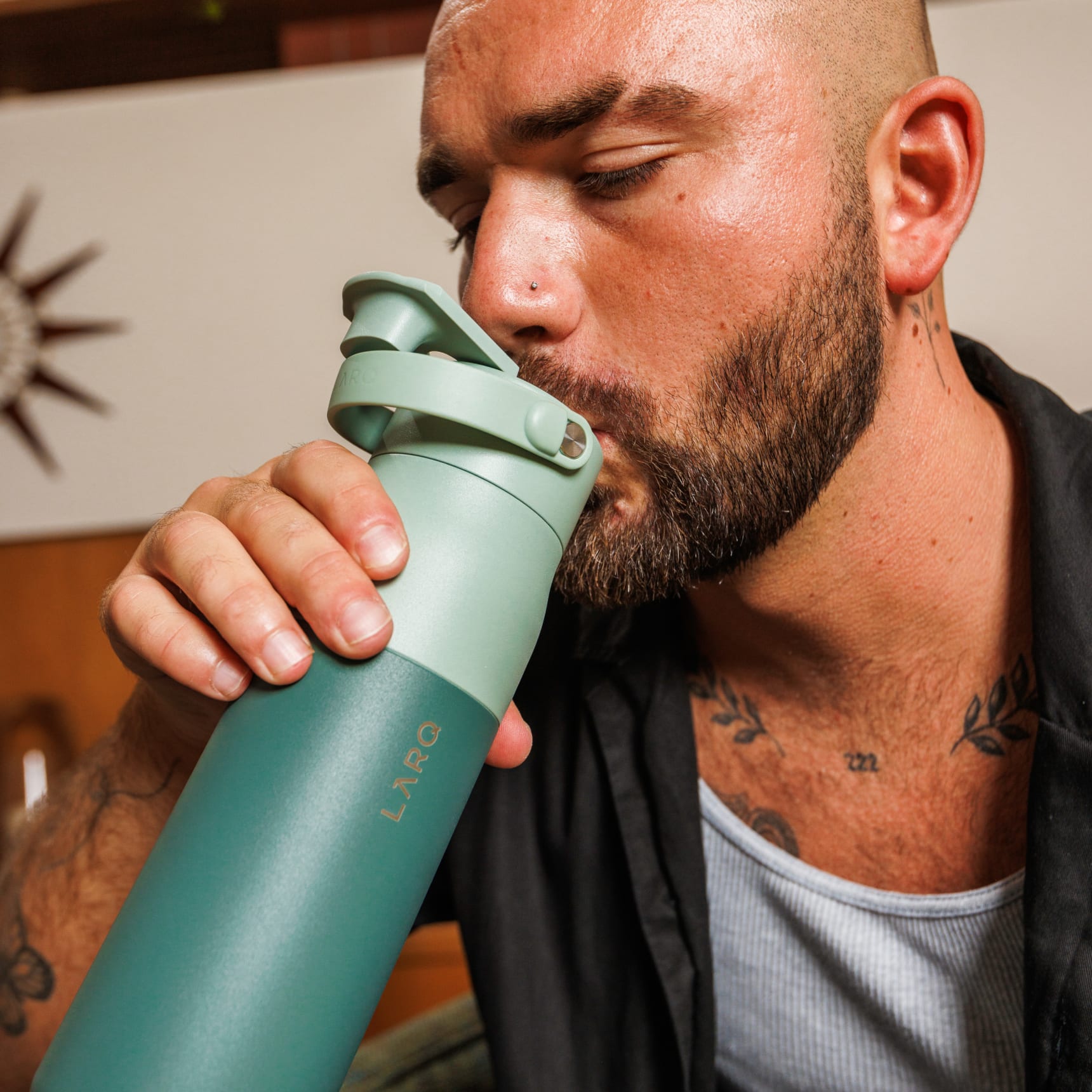 Man drinking water from Larq bottle swig top