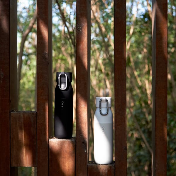 Photo of Active Loop with LARQ Bottle PureVis&trade; Obsidian Black and LARQ Bottle Granite White standing upright