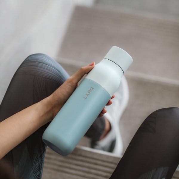 Photo of LARQ Bottle PureVis&trade; - Seaside Mint in hands on staircase