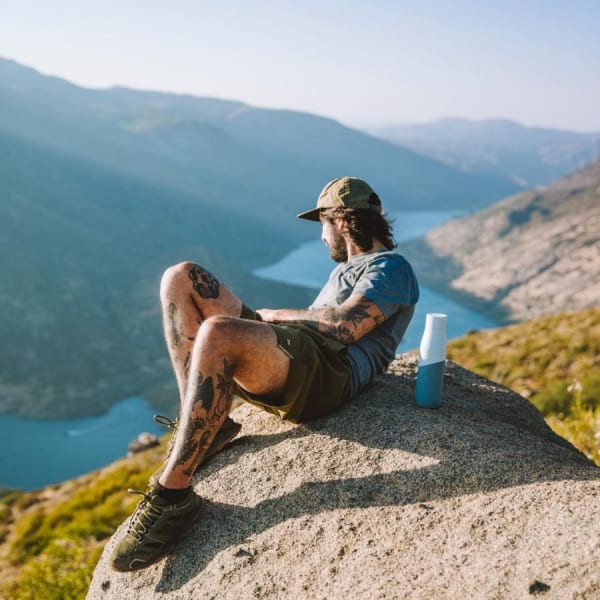 Photo of Larq Bottle PureVis&trade; - White / Marine with a man on a viewpoint